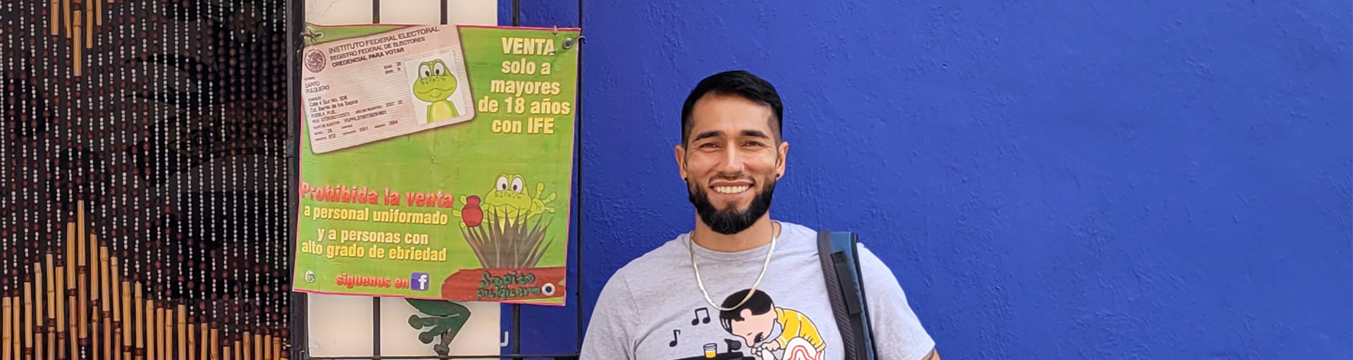 Student in front of blue wall