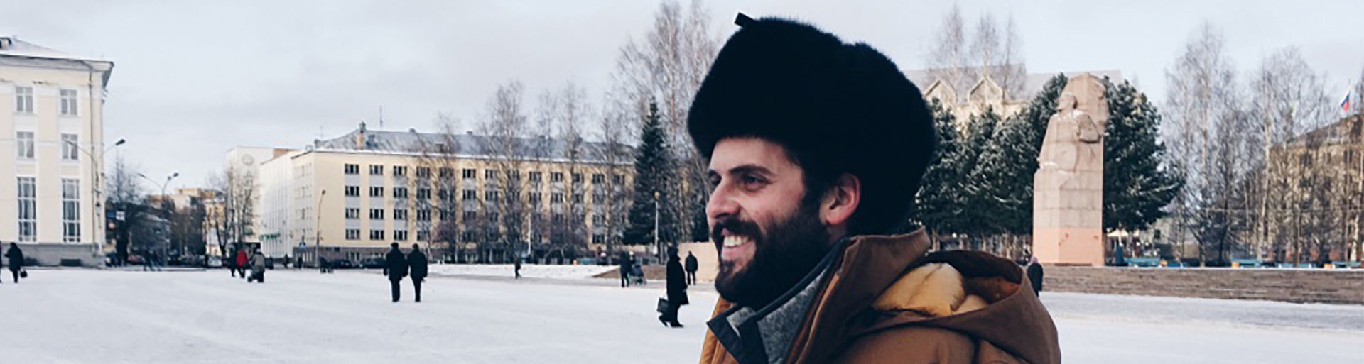 Person wearing winter apparel with snow in the background